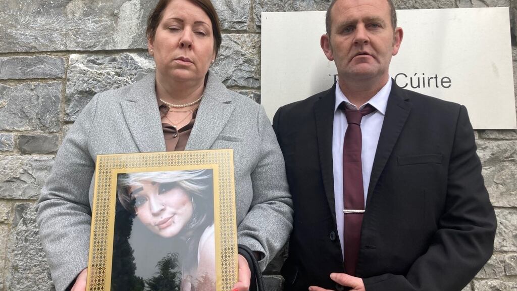 Melanie Sheehan and Barry Cleary hold a photograph of their daughter Eve Cleary outside Limerick Coroners Court. Photograph: David Raleigh.