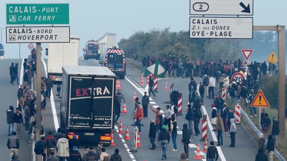 Calais camp: people head for the town’s ferry port and the Channel Tunnel, in the hope of reaching Britain. Photograph: Pascal Rossignol/Reuters