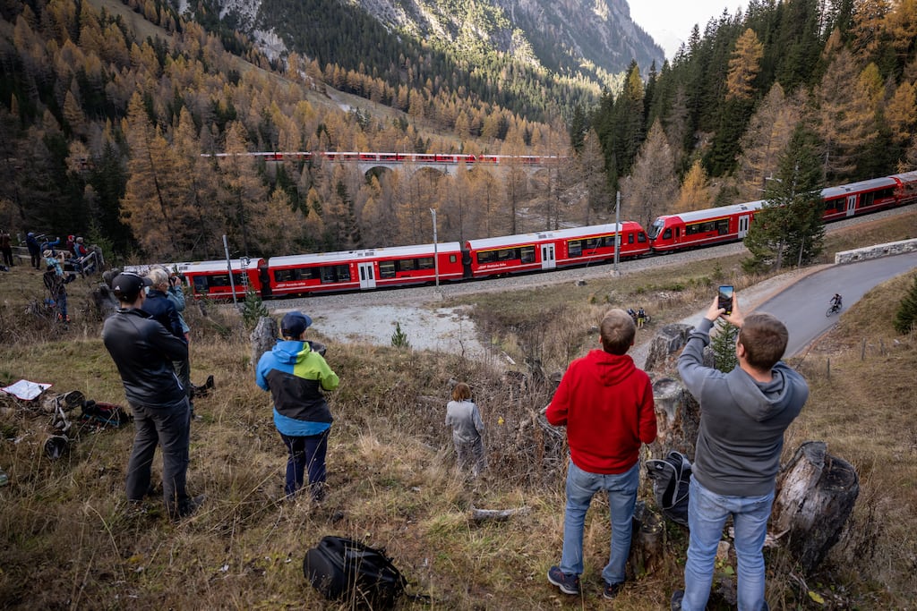 Spectators capture images as a 1,910m long train passes near Bergun in Switzerland. Photograph: Fabrice Coffrini/AFP