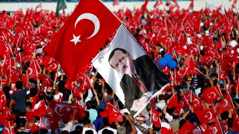 People wave Turkish flags and a flag of president Erdogan during a rally in Istanbul. Photograph: Murad Sezer/Reuters