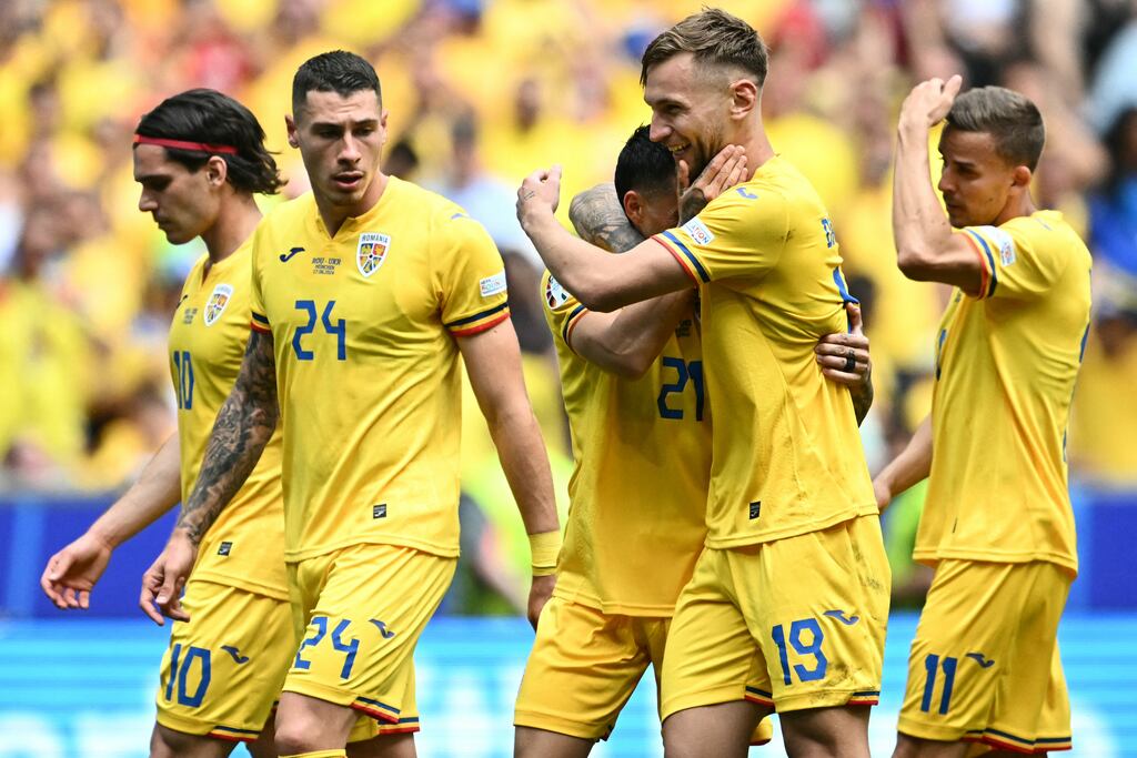 Romania's players celebrate after match. Photograph: Fabrice Coffrini/AFP via Getty