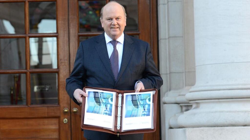 Minister for Finance Michael Noonan outside Government Buildings before delivering Budget 2013 last December. Photographer: Dara Mac Dónaill/The Irish Times