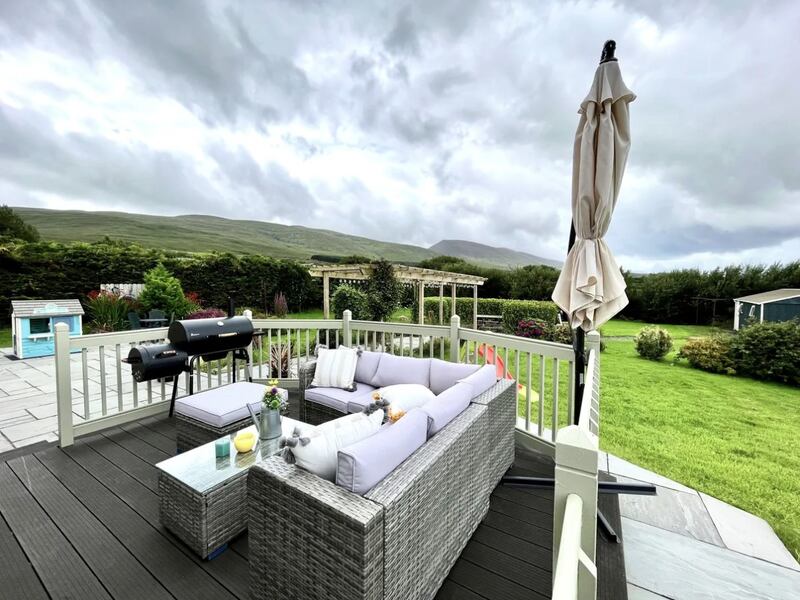 A decked dining terrace provides the perfect spot from which to appreciate the view of the mountains