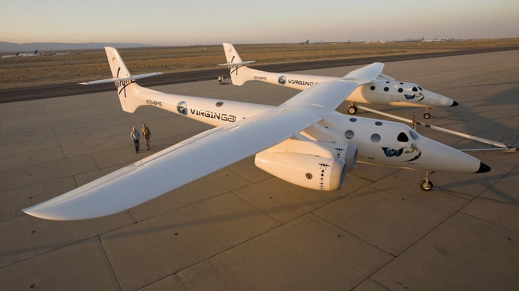 Richard Branson walks near Virgin Galactic’s mothership WhiteKnightTwo,  intended to carry SpaceShipTwo to launch commercial passengers into space. Photograph: Mark Greenberg/Virgin Galactic/Reuters