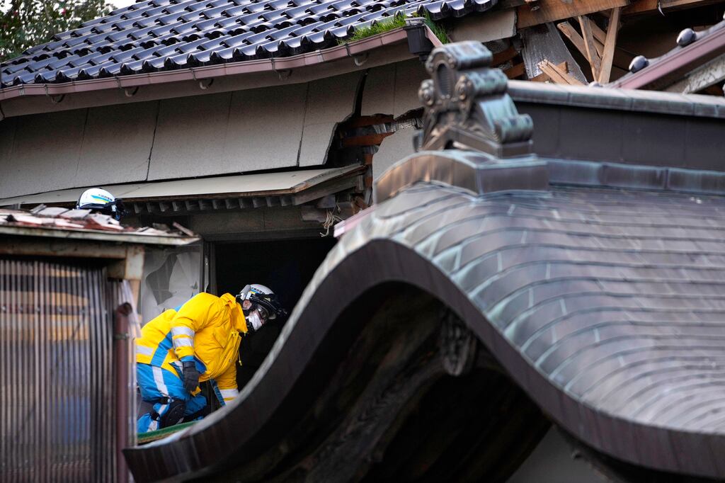Police officers going into a temple after the 7.6 magnitude tremor hit Japan on Monday. Photograph: AP Photo/Hiro Komae