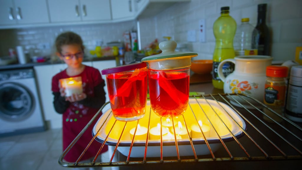 A power cut in Lili Petrik’s home in Innishannon, Co Cork, following Storm Ophelia. Lili’s mother warms herbal tea using tealights. The house is also without heating. Photograph: Daragh McSweeney/Provision