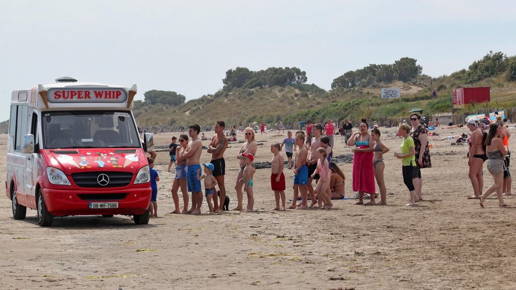 Cooling down, people pictured enjoying the summer heatwave on Portmarnock Strand. Photograph: Colin Keegan/Collins Dublin