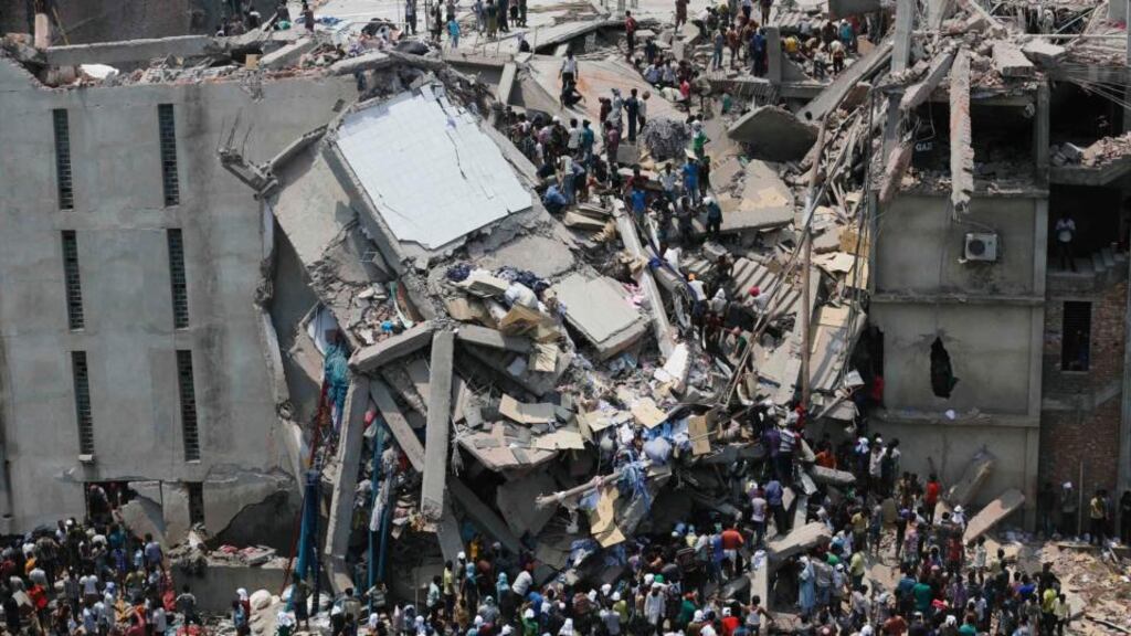 People rescue garment workers trapped under rubble at the Rana Plaza building after it collapsed, in Savar, 30 km outside Dhaka today. Photograph: Andrew Biraj/Reuters