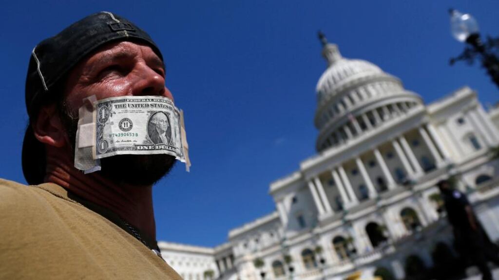 John Zangas, who identified himself as a federal employee, protests against the current government shutdown at the US Capitol in Washington yesterday. Photograph: Reuters.