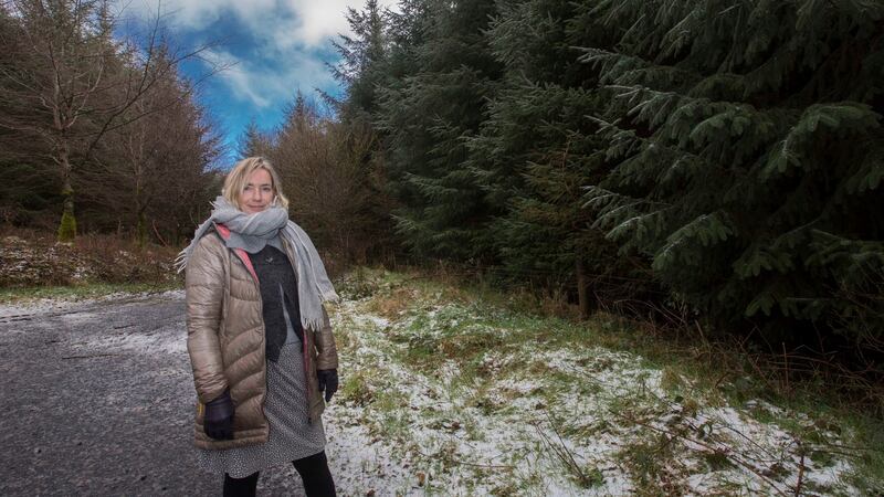 Artist Anna Macleod outside her Leitrim home surrounded by Sitka spruce. Photograph: Brian Farrell