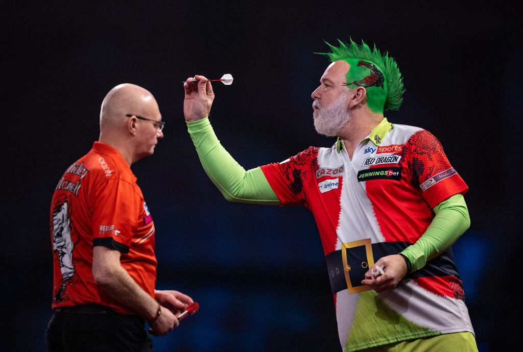 Peter Wright and Mickey Mansell in action day one of the Cazoo World Darts Championship at Alexandra Palace in London. Photograph: Steven Paston/PA Wire