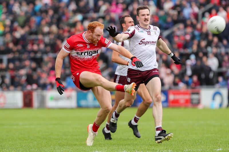 Derry's Conor Glass scores a point as Galway's Céin Darcy challenges. Photograph: Lorcan Doherty/INPHO
