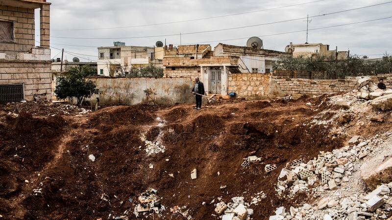 A man holding a shovel surveys a crater left by what locals said was a Scud missile strike in Shilakh, in Syria’s Idlib province, on March 8th, 2013. Photograph: Bryan Denton/New York Times
