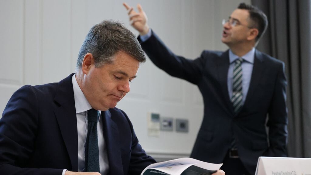 Paschal Donohoe checks his figures as Department of Finance chief economist John McCarthy presents on Thursday. Higher growth forecasts are not expected to make the Budget 2022 package any bigger. Photograph: Nick Bradshaw/The Irish Times