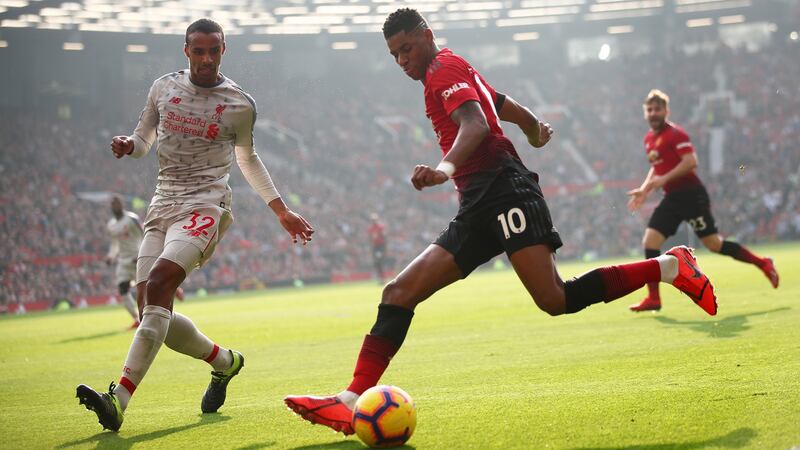 Joel Matip challenges Marcus Rashford during Liverpool’s goalless draw with Manchester United at Old Trafford. Photograph: Clive Brunskill/Getty