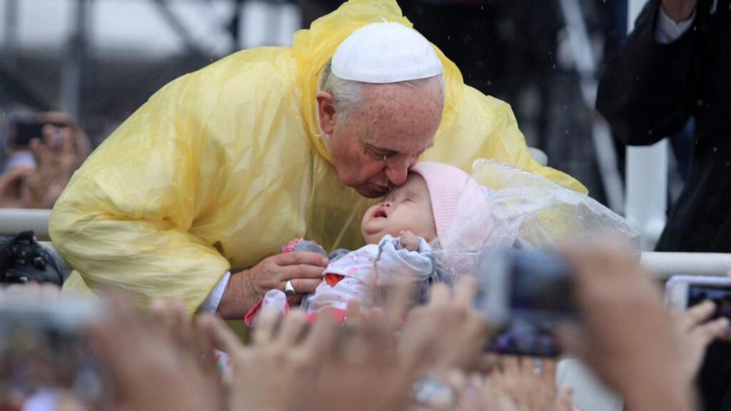 Pope Francis kisses a Filipino baby prior to his mass in Quirino grandstand, Manila, Philippines, on Sunday. Photograph: EPA