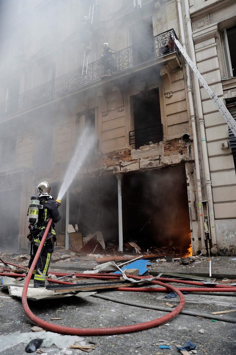 Firefighters extinguish a fire after the explosion of a bakery on the corner of the streets Saint-Cecile and Rue de Trevise in central Paris. Photograph: Thomas Samson/AFP/Getty Images