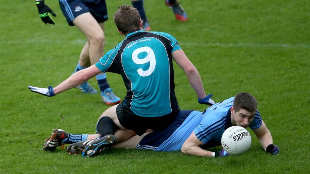 Emmett O’Conghaile of Dublin with Padraig Faulker of Maynooth University at Parnell Park.  Photograph: Donall Farmer / Inpho