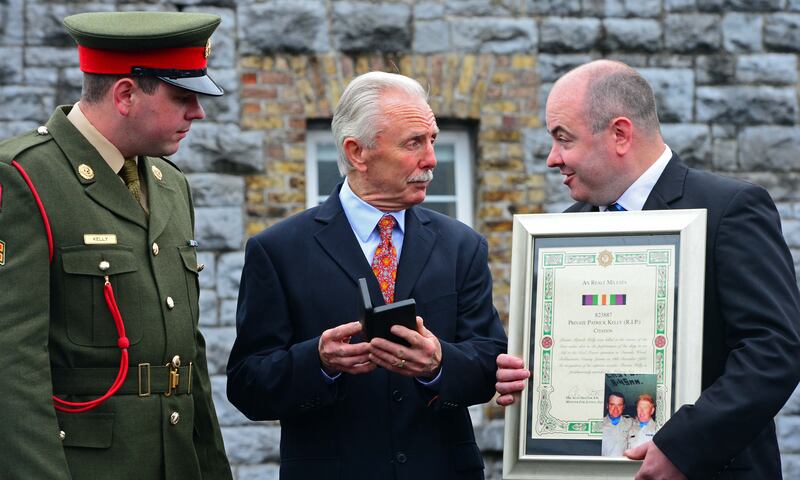 Corporal Andrew Kelly (left) and David Kelly, accepting the Military Star and citation on behalf of their father, Private Patrick Kelly, with Don Tidey (centre), at a ceremony in Athlone in July 2012. Pte Kelly died during the operation to rescue Mr Tidey. Photograph: Eric Luke/The Irish Times