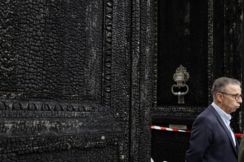 Pierre Hurmic, mayor of Bordeaux, stands in front of the burned door of the city hall a day after it was set on fire by demonstrators during a rally against pension reform. Photograph: Romain Perrocheau/AFP via Getty Images