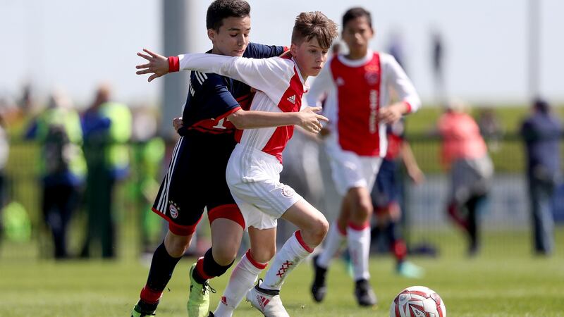 Bayern Munich’s Ediz Demircan with Bram van Driel of Ajax. Photograph: Tommy Dickson/Inpho