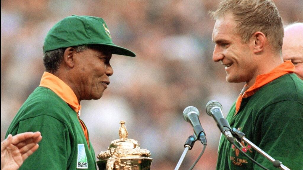 South Africa’s president Nelson Mandela handing the William Webb trophy to South Africa’s captain Francois Pienaar in Johannesburg in 1995. Photograph: Jean-Pierre Muller/AFP via Getty Images
