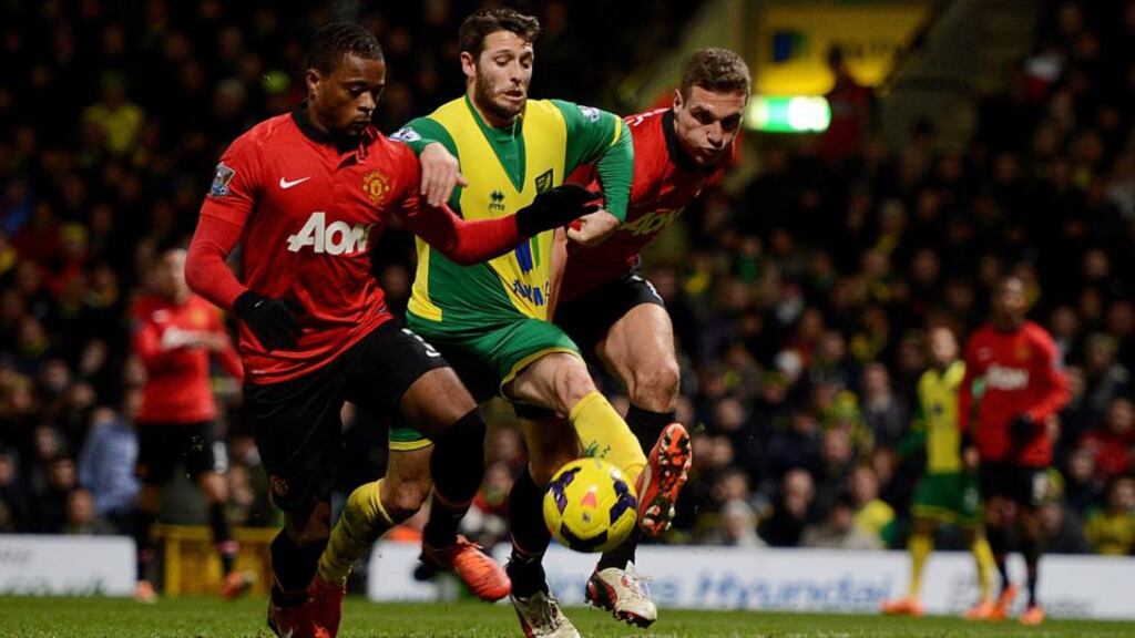 Wes Hoolahan of Norwich City in action against Patrice Evra and Nemanja Vidic of Manchester United during the Premier League match at Carrow Road. Photograph: Michael Regan/Getty Images