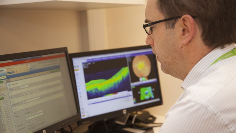 Ophthalmologist Dr Pearse Keane analyses an optical coherence tomography scan, which provides a detailed map of the eye.