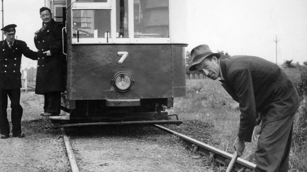 Rail worker Thomas McGlue with his shovel fixing the tram line, with two crew members. Photograph: Jack McManus / The Irish Times