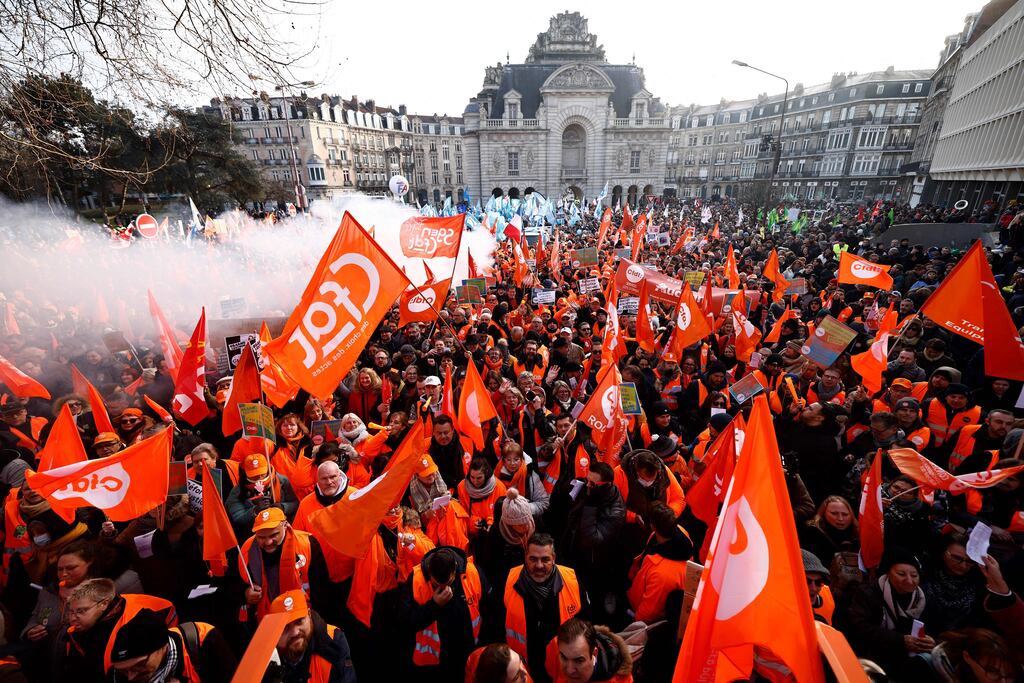 Demonstrators wave trade union flags during a protest in Lille on Thursday against French president Emmanuel Macron's planned pension reform. Photograph: Sameer Al-Doumy/AFP via Getty Images