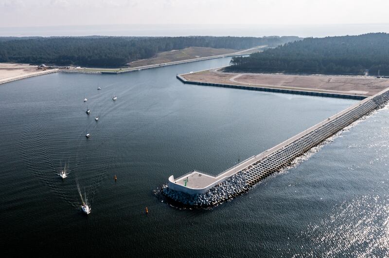 Boats sail out of the Vistula Spit canal (Nowy Swiat ship canal) near Skowronki, northern Poland. The canal crosses the Polish section of the Vistula Spit to connect the Vistula Lagoon and the Baltic Sea. Photograph: Mateusz Slodkowski/AFP/Getty
