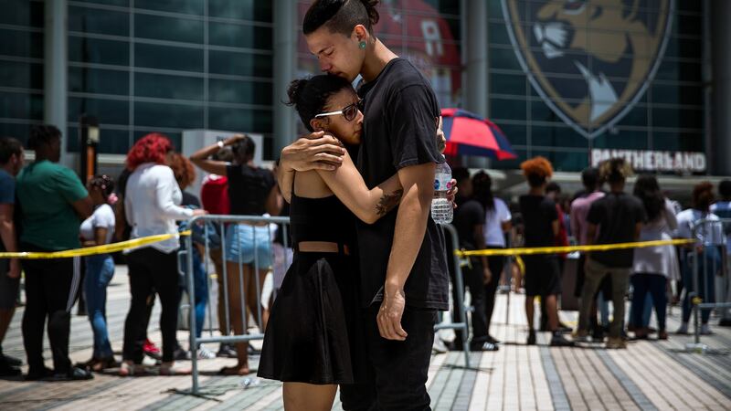 Mourners console each other at a memorial and viewing for rapper XXXTentacion. Photograph: Scott McIntyre/The New York Times.