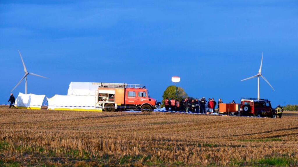 Police officers inspect the scene of a plane crash in eastern Belgium today. A small Pilatus plane carrying a group of skydivers crashed, killing all 11 people on board, a fire brigade spokesman said. Photograph: Eric Vidal/Reuters