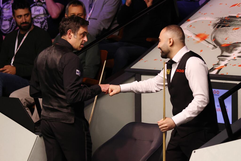 Ronnie O'Sullivan touches kneckles with Hossein Vafaei prior to their round two match at the World Snooker Championship at the Crucible Theatre in Sheffield. Photograph: George Wood/Getty Images