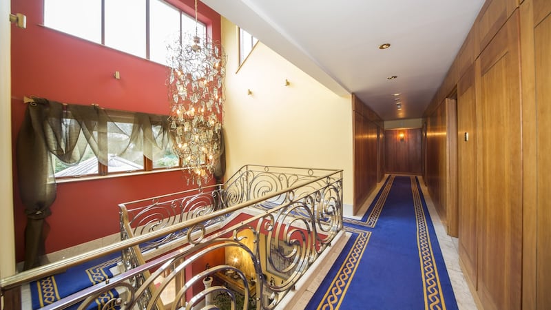 The upstairs landing resembles a ship’s corridor flush with hand-tufted carpet and cherrywood panelled walls.