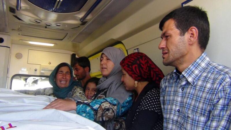 Abdullah Kurdi with relatives during a funeral in Kobane, Syria, for his wife and sons. Photograph: EPA.