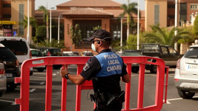 A Spanish police officer sets a barrier blocking the access to the H10 Costa Adeje Palace hotel in Tenerife, Canary Islands, Spain. Photograph: AP Photo
