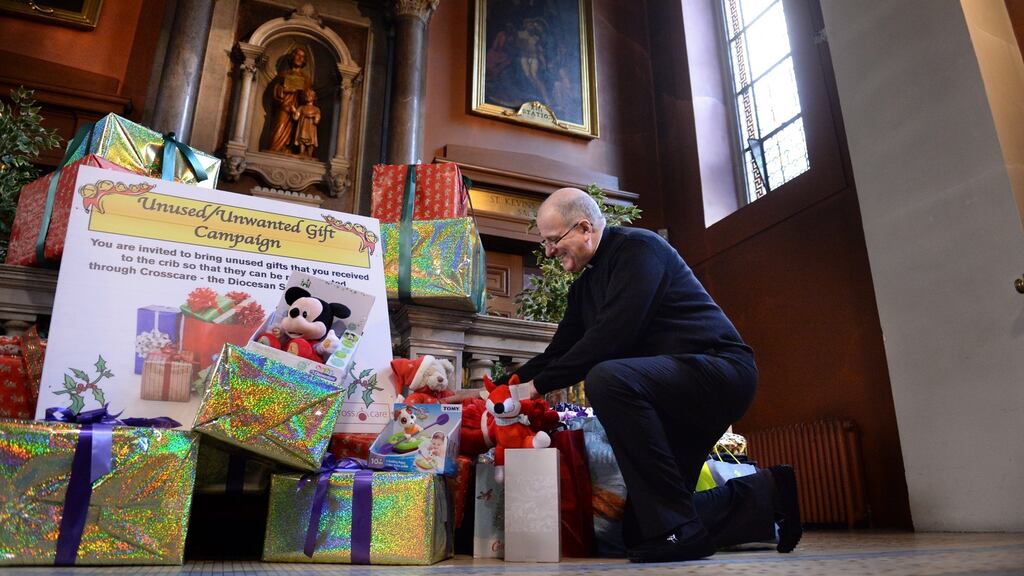Canon Damian O’Reilly looks through some of the unwanted Christmas gifts left at St Mary’s Pro-Cathedral, Dublin, in 2016. File photograph: Dara Mac Dónaill/The Irish Times