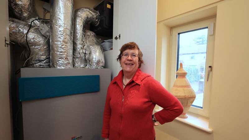 Pauline Conway with her mechanical heat recovery ventilation system. Photograph: Nick Bradshaw