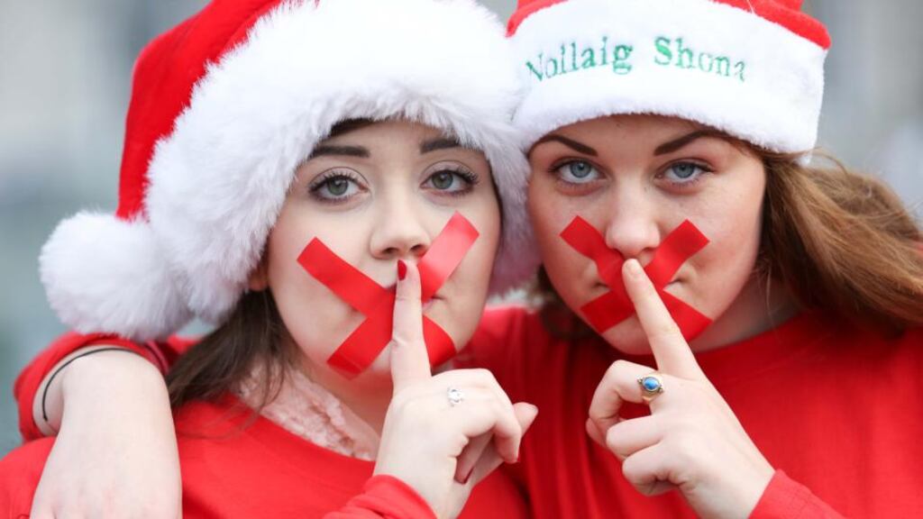 Members of Conradh na Gaeilge and the Union of Students in Ireland (USI) wore red tape across their mouths at a protest outside Leinster House today demanding that the Government act on its legal obligations to give Irish language speakers equality in their right to engage with the State through Irish.