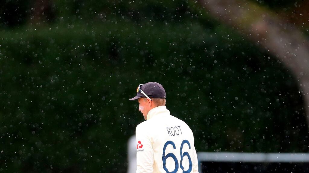 England’s captain Joe Root walks off the field as rain stops play on the fifth day of the second Test match between England and New Zealand at Seddon Park in Hamilton. Photo: David Gray/Getty Images