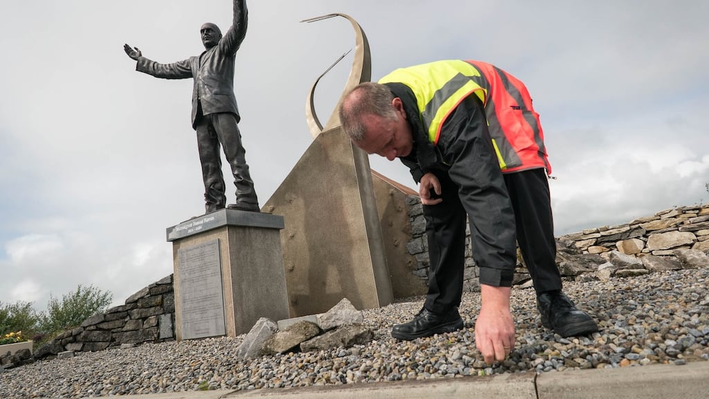 Noel Jennings, fire and security duty officer at Ireland West Airport Knock, pulling weeds beside the statue of Msgr Horan in preparation for the visit of Pope Francis. Photograph: Keith Heneghan