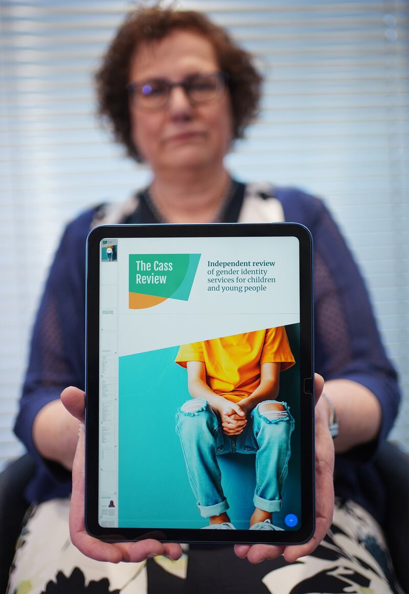 Retired consultant paediatrician Dr Hilary Cass shows a device displaying the Independent Review of Gender Identity Services for Children and Young People (the Cass Review) which has just been published. Photograph: Yui Mok/PA Wire
