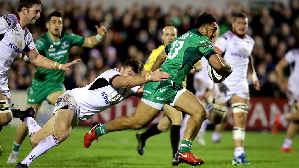 Connacht’s Bundee Aki skips past Jacob Stockdale of Ulster on his way to scoring his side’s second try during the Guinness Pro 14 game at the Sportsground in Galway. Photograph: Ryan Byrne/Inpho