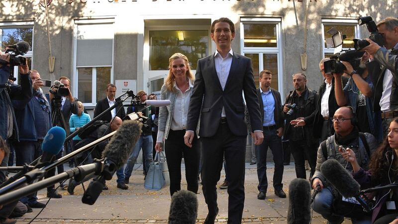 Austria’s foreign minister and leader of Austria’s centre-right People’s Party (OeVP) Sebastian Kurz and his partner Susanne Thier leave a polling station during general elections on Sunday. Photograph: Getty