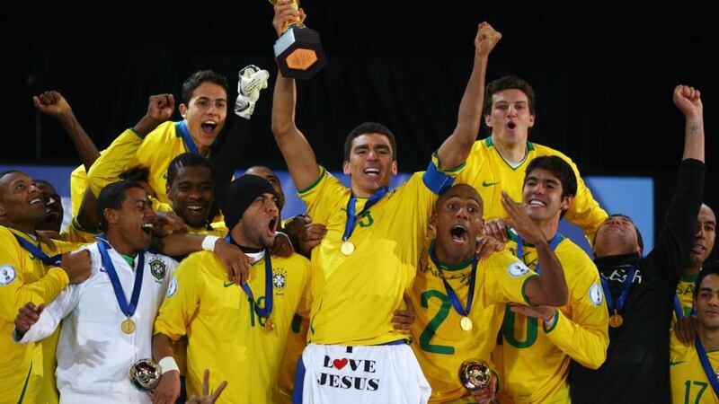 Lucio of Brazil lifts the trophy as his team-mates celebrate following their victory at the end of the Fifa Confederations Cup Final between USA and Brazil at the Ellis Park Stadium on June 28, 2009 in Johannesburg, South Africa. Photograph: Alex Livesey/Getty Images