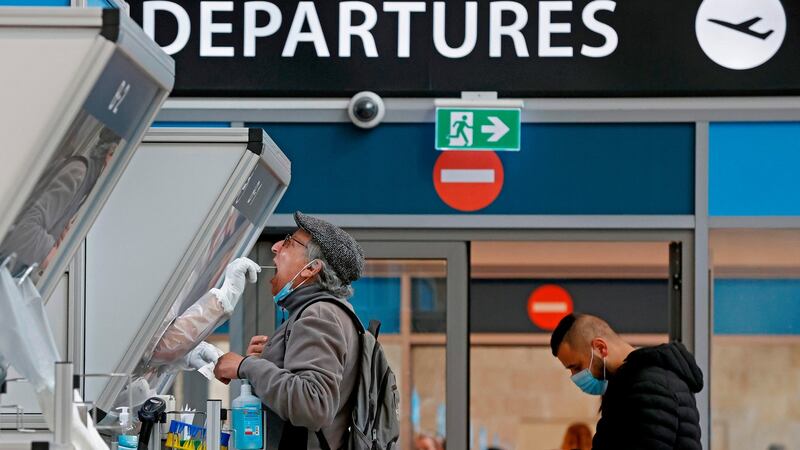 A medic collects a swab sample from a traveller at a booth at the Covid-19 coronavirus rapid testing centre in Israel’s Ben-Gurion Airport in Lod, near Tel Aviv. File photograph: Jack Guez/Getty