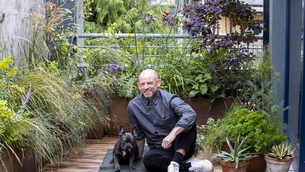 Mark Grehan and his French bulldog, Finn, in his garden at his apartment in Cork Street, Dublin. Photograph: Tom Honan