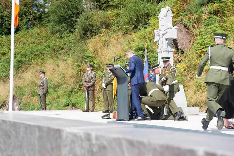 A member of the Flag Troop collapses in the heat as Taoisech Micheál Martin speaks. Photograph: Michael Mac Sweeney/Provision