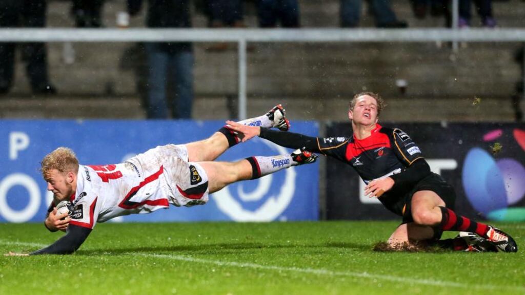 Ulster’s Stuart Olding scores his first try despite the best efforts of Dragons’ Angus O’Brien. Photograph: Darren Kidd / Presseye / Inpho
